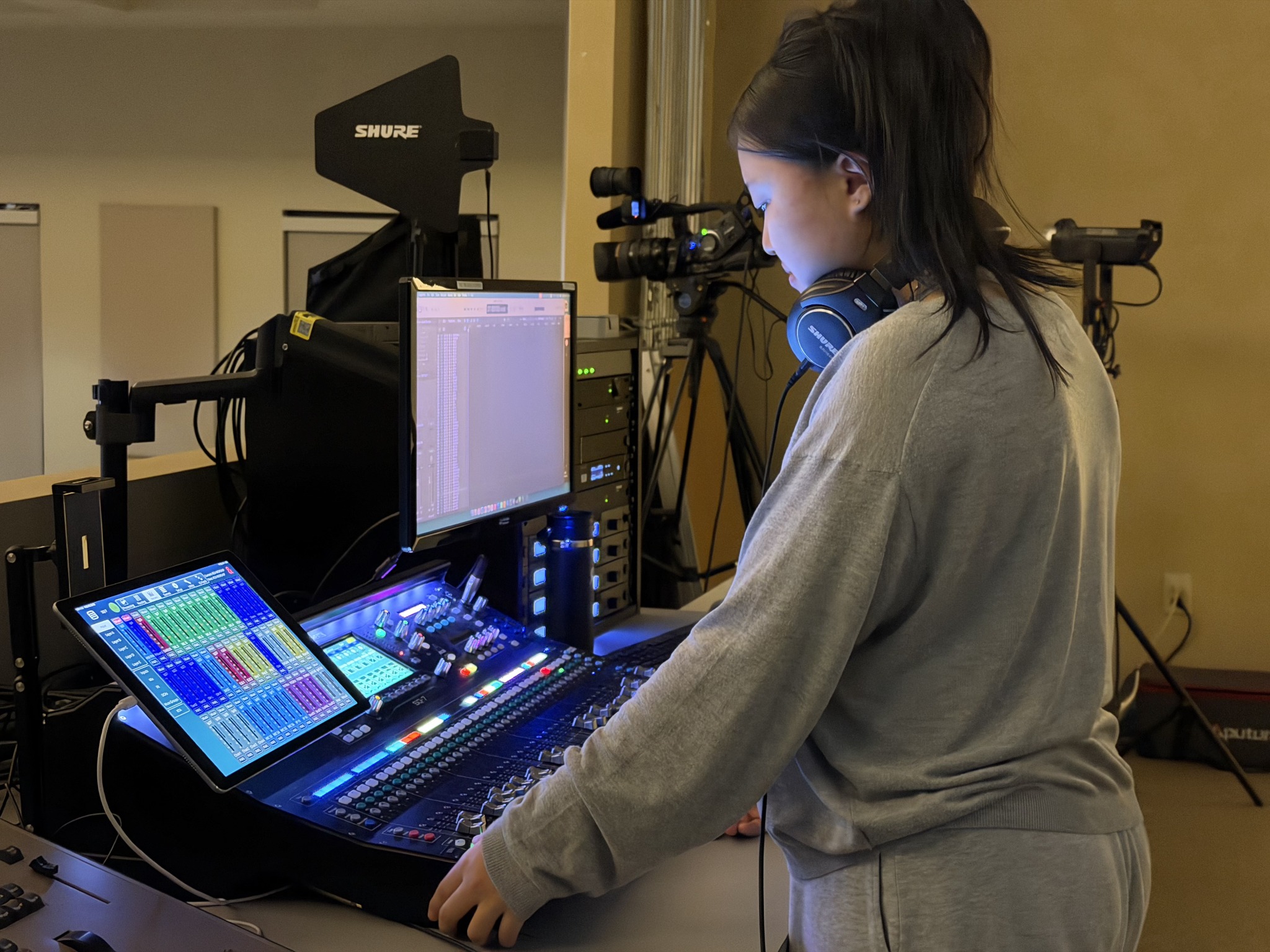 Jihyo operating a video switcher during church media production